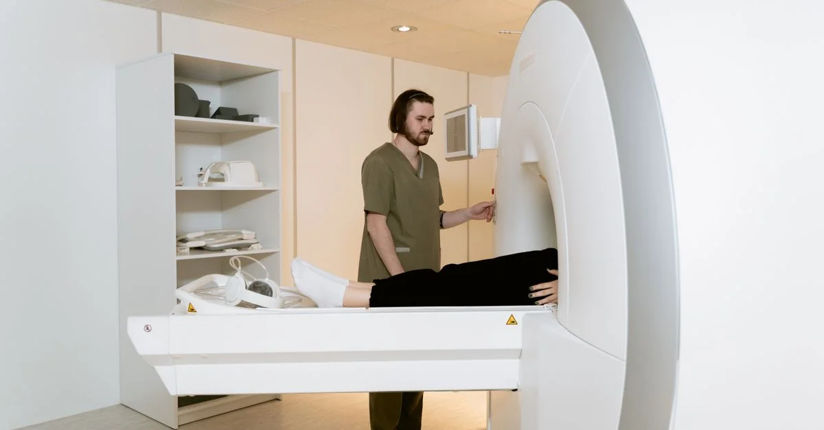 Profesional médico asistiendo a un paciente durante una resonancia magnética en un entorno hospitalario.